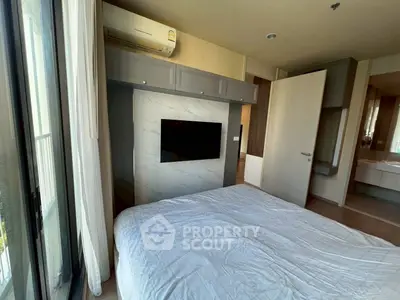 Modern bedroom with large window, air conditioning, and built-in TV for a comfortable living experience.