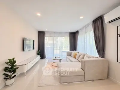 Spacious modern living room with large windows and elegant decor