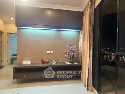 Modern living room with elegant decor and stunning city view at night.