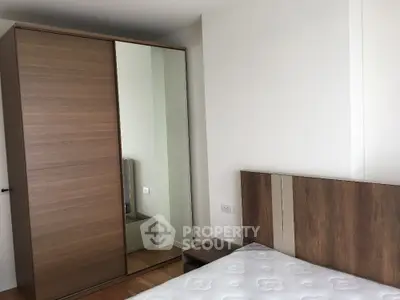 Modern bedroom with wooden wardrobe and stylish bed in minimalist design