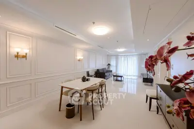 Elegant open-plan living and dining area with modern decor and ample natural light.