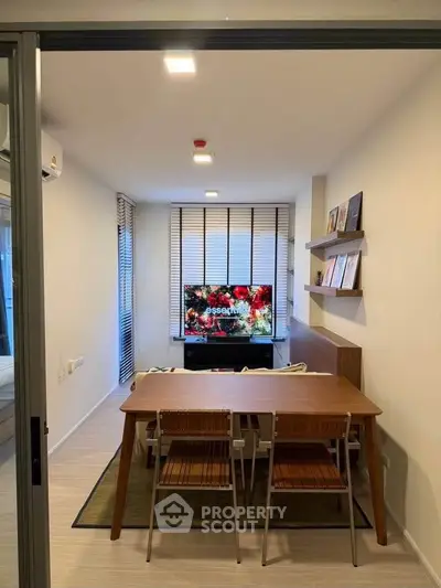Modern living room with sleek furniture and wall-mounted TV, perfect for cozy gatherings.