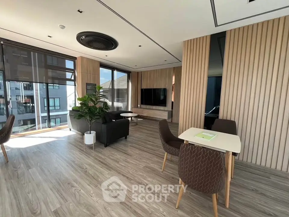 Modern living room with stylish decor and large windows in a contemporary apartment.