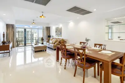 Spacious modern living room with elegant dining area and large balcony view.