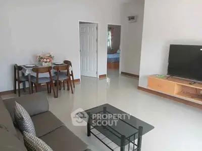 Spacious living room with modern furniture and dining area, perfect for family gatherings.
