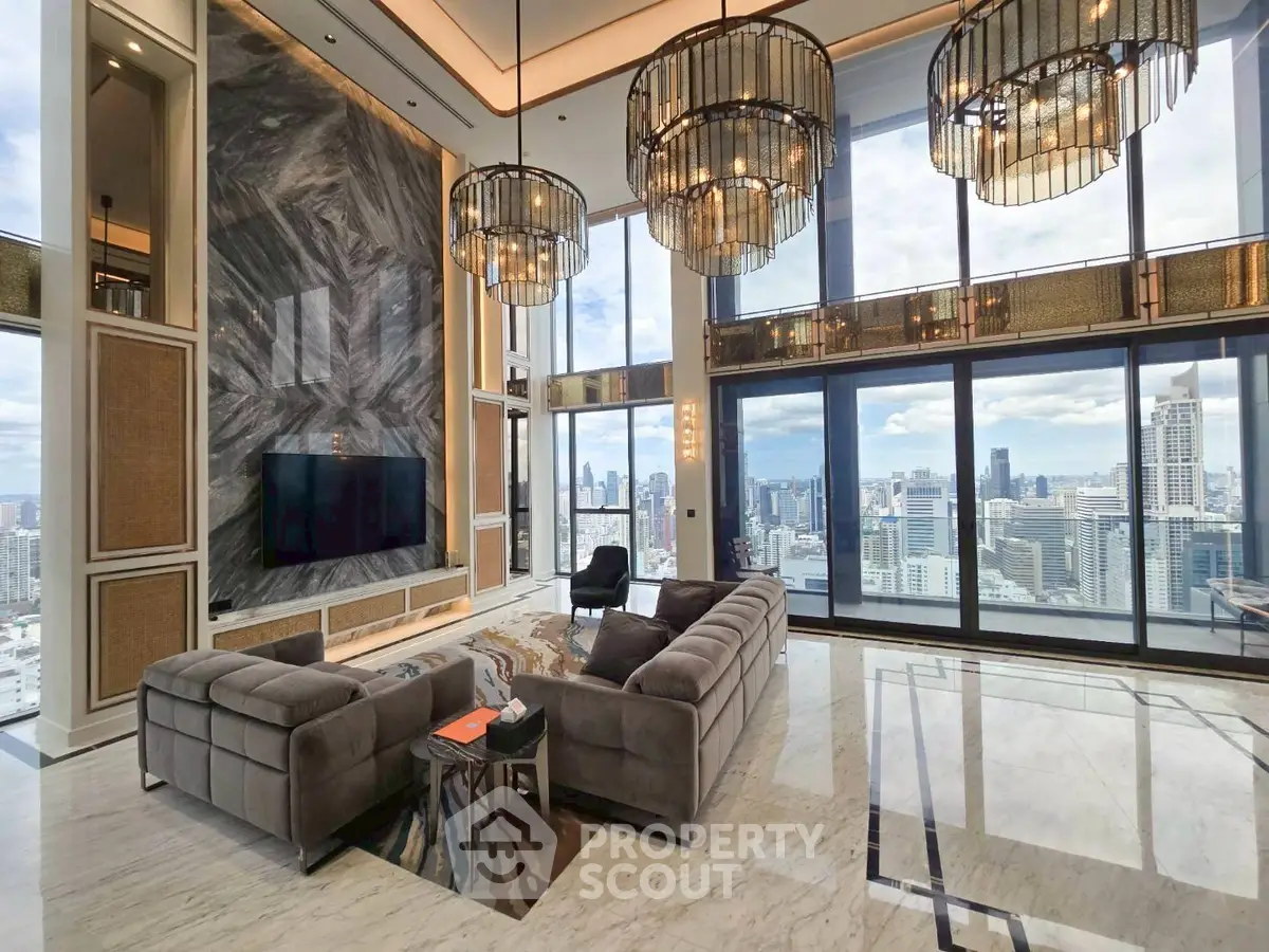 Luxurious penthouse living room with panoramic city views and elegant chandeliers.