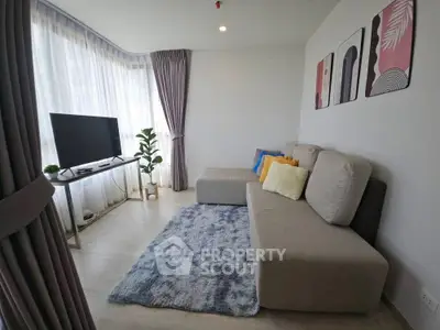 Modern living room with stylish decor and large windows for natural light.