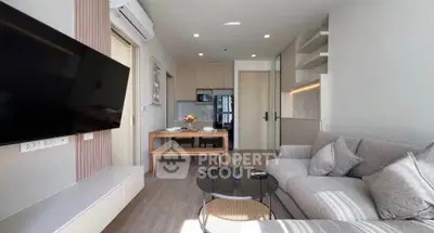 Modern living room with sleek furniture and open kitchen layout
