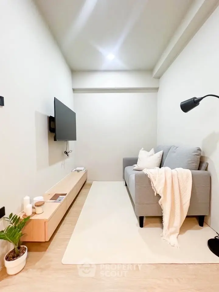 Cozy minimalist living room with modern sofa and wall-mounted TV