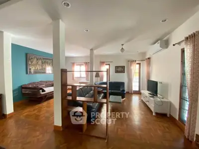 Spacious living room with wooden flooring and modern furniture