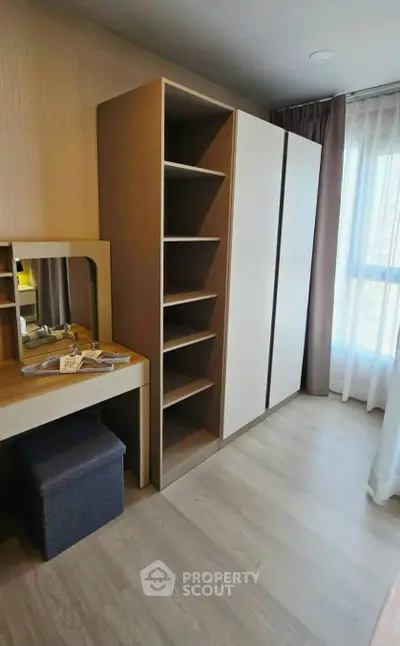 Modern bedroom with sleek wardrobe and vanity in a bright apartment