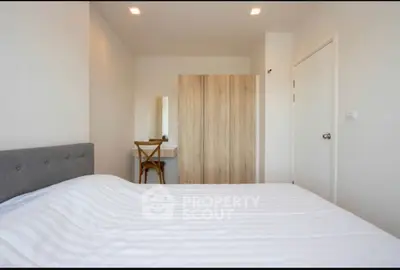 Modern minimalist bedroom with stylish furniture and cozy ambiance.