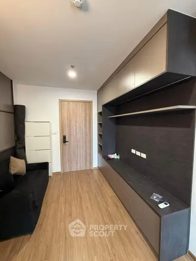 Modern living room with sleek built-in storage and wooden flooring