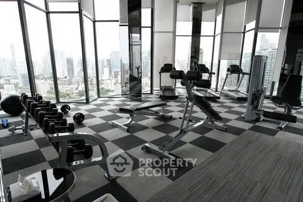 Luxurious high-rise gym with panoramic city views and modern fitness equipment.