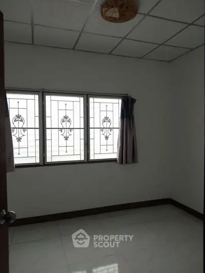 Spacious bedroom with elegant window grills and natural light