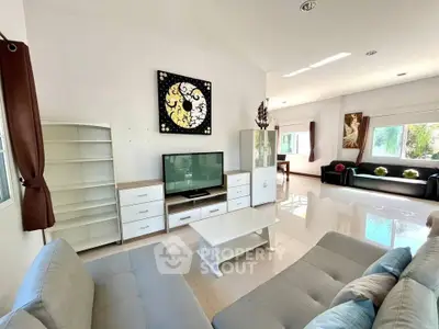 Spacious living room with modern decor and ample natural light