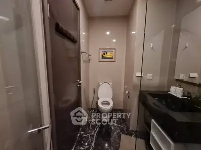 Luxurious bathroom with elegant marble flooring and modern fixtures in a high-end property.