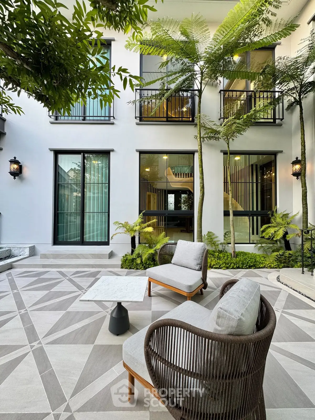 Luxurious modern garden patio with stylish furniture and lush greenery