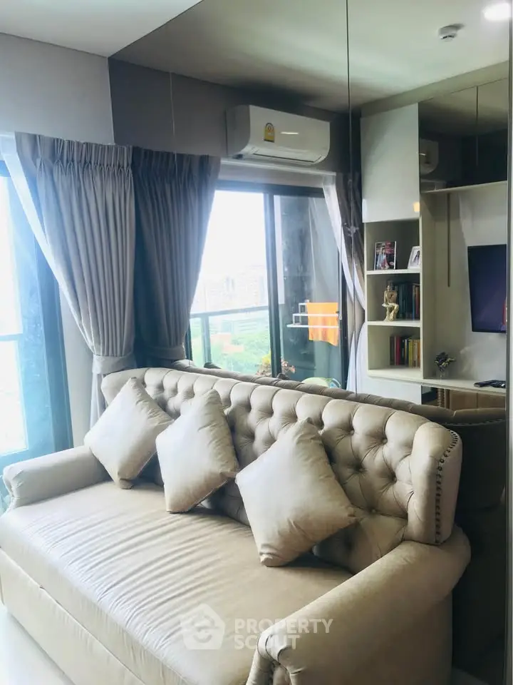 Stylish living room with plush sofa and large window view