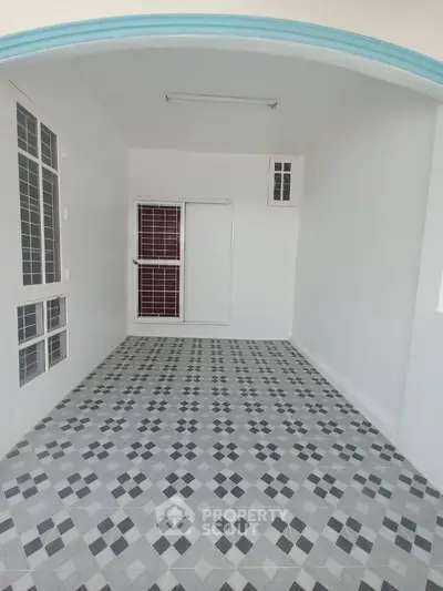 Spacious tiled balcony with modern design and ample natural light