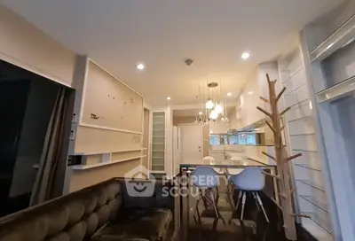 Modern open-plan living room with stylish kitchen and unique lighting fixtures.