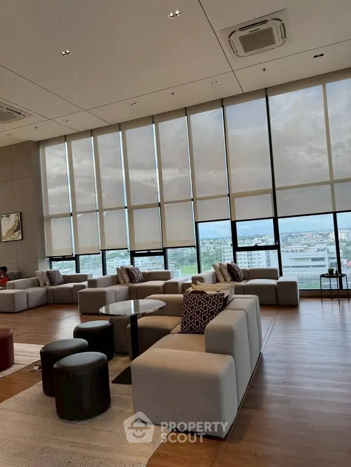 Luxurious modern living room with floor-to-ceiling windows and stylish furniture.