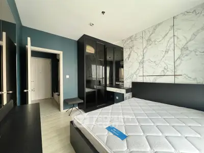 Modern bedroom with stylish decor and large mirrored wardrobe