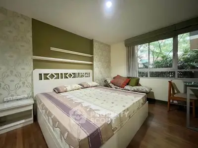 Cozy bedroom with large window and stylish decor, perfect for relaxation and comfort.