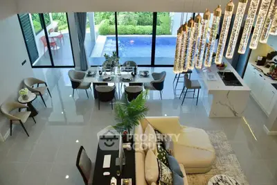 Luxurious open-plan living room with pool view and elegant dining area
