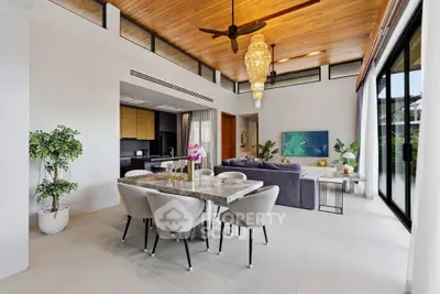 Luxurious open-plan living room with high ceilings, elegant dining area, and modern kitchen in a stylish home.