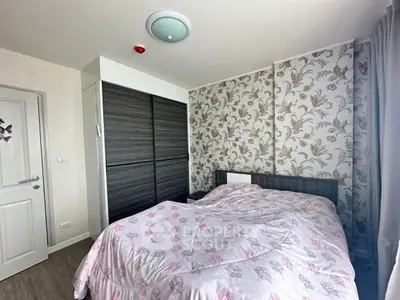 Cozy bedroom with floral wallpaper and modern wardrobe, perfect for a restful retreat.