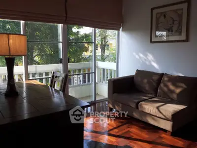 Cozy living room with natural light and balcony view