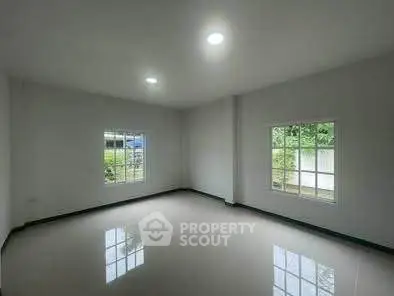 Spacious empty room with large windows and glossy floor, perfect for customization.