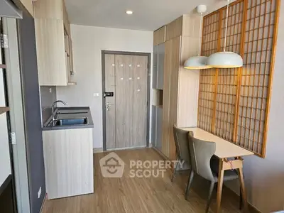 Modern apartment interior with compact kitchen and dining area