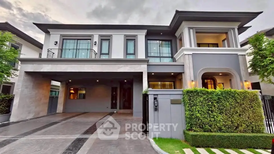 Luxurious modern two-story house with elegant facade and spacious driveway in upscale neighborhood.