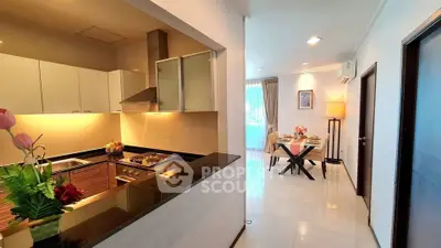 Modern open kitchen with sleek design and cozy dining area in a stylish apartment.