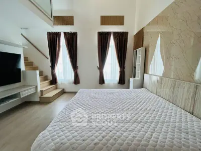 Spacious modern bedroom with elegant decor and natural light