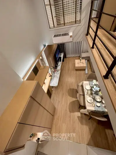 Stunning loft-style living room with modern decor and elegant dining area, perfect for urban living.