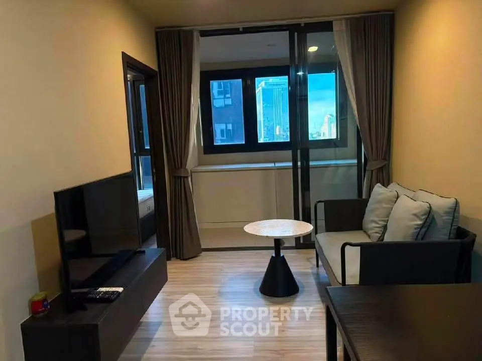 Modern living room with sleek furniture and city view, perfect for urban living.
