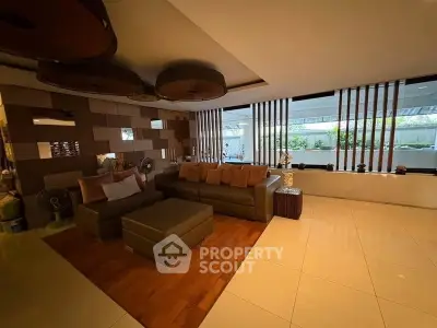 Spacious modern living room with stylish decor and large windows for natural light.