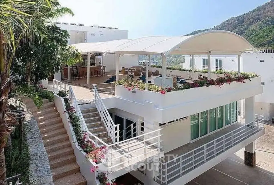 Stunning modern villa with rooftop terrace and lush greenery