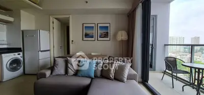 Modern apartment with open kitchen, cozy living area, and balcony with city view.