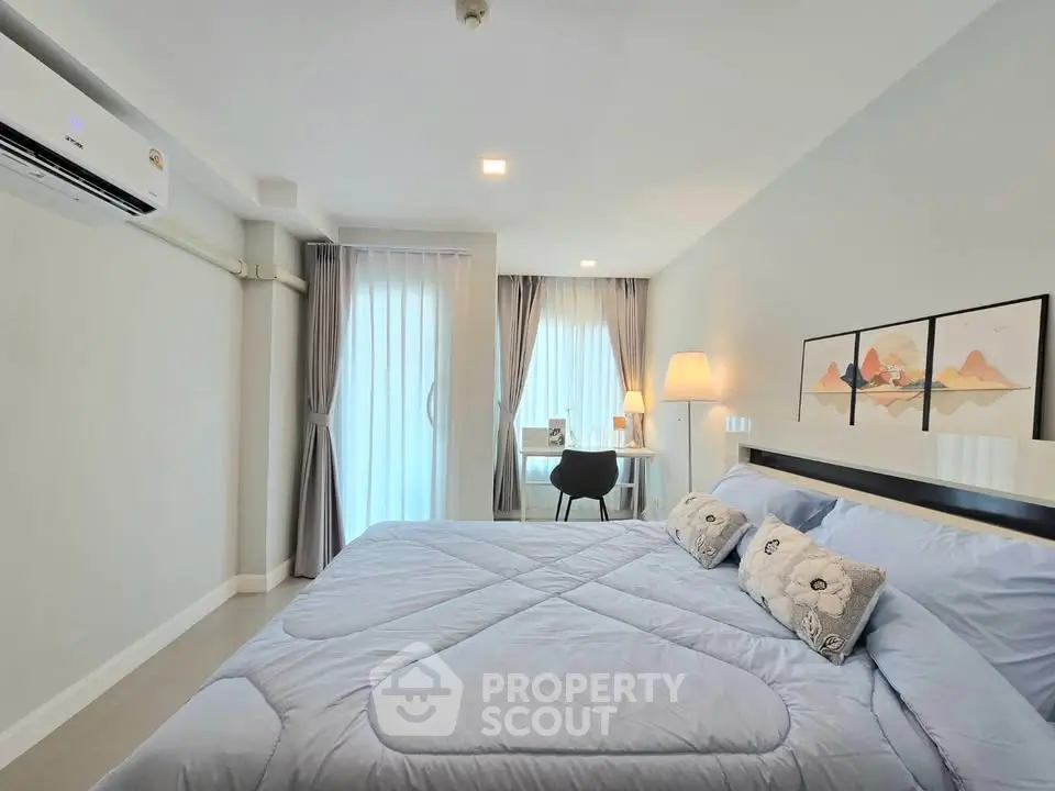 Spacious modern bedroom with elegant decor and natural light
