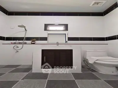 Modern bathroom with sleek design, featuring a shower and contemporary fixtures.