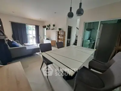 Modern living room with dining area and stylish decor in a spacious open layout.