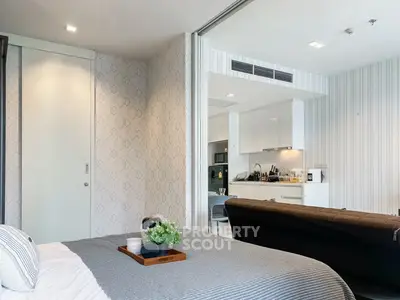 Modern studio apartment with open kitchen and cozy bedroom area