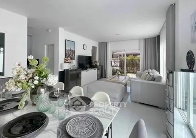 Spacious modern living room with elegant dining area and large windows