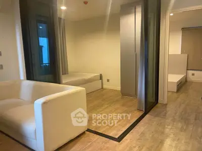 Modern studio apartment with sleek wooden flooring and cozy furniture.