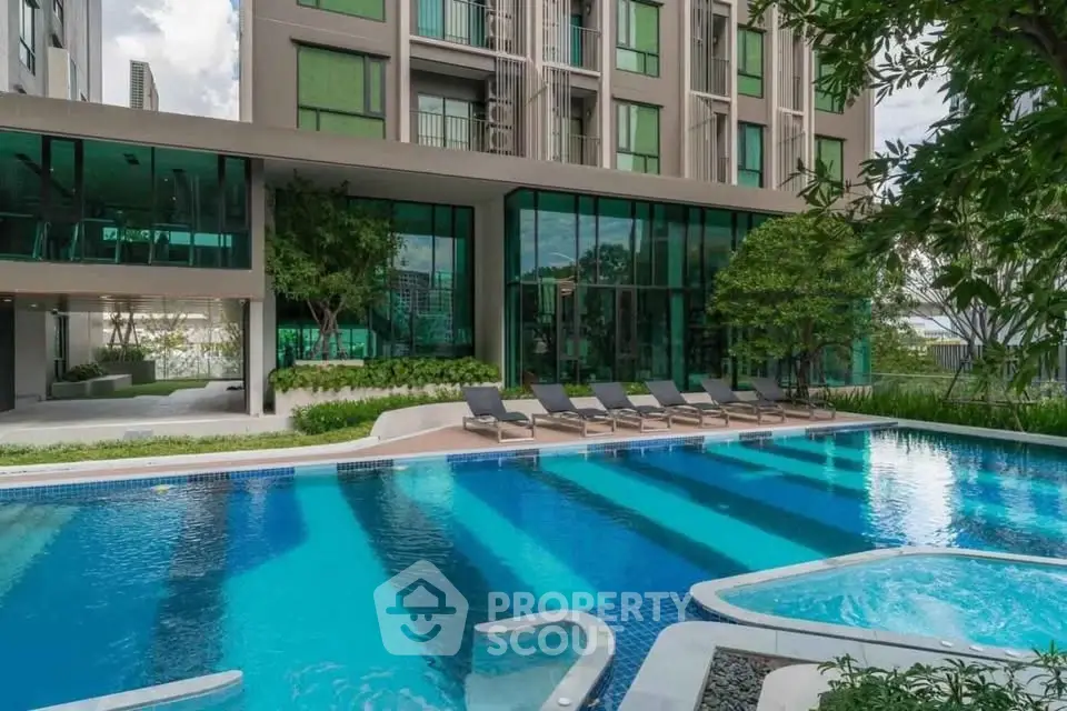 Luxurious apartment complex with stunning pool and lush greenery, perfect for relaxation and leisure.