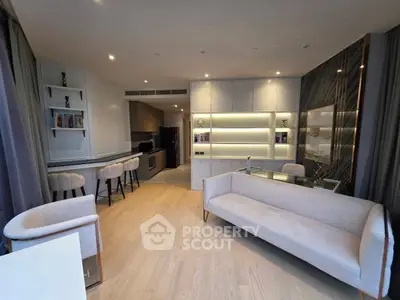 Luxurious modern living room with elegant decor and open kitchen layout.
